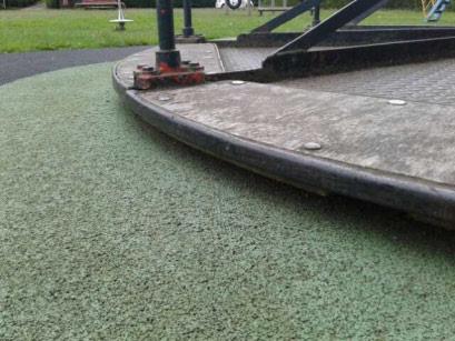 Wicksteed Playgrounds Surface: Wet Pour The distance between the underside of the roundabout platform and the playing surface is less than 60mm and contravenes the