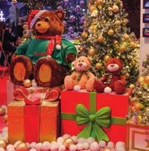 Santa's socks, golden bags and other small Christmas ornaments Green grass made of material Artificial snow Wooden floor