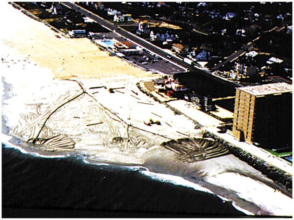 Beach Nourishment = The artificial addition of sand to the beach to reduce the rate of beach erosion. And, it does not cause down-drift erosion.