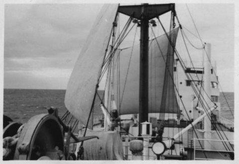 The second square sail was prepared in the same manner as the first with the addition of a row of eyelets across the head of it, for owing to the absence of suitable samson posts a different rig had