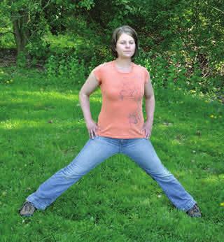 Kneel in the grass, keeping your back straight, making sure your knees are directly beneath your hips.