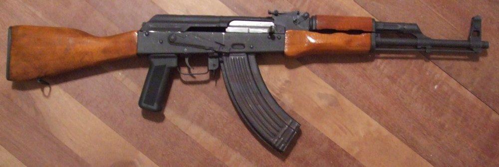 To sum up the operating principles of the AK-47 as concisely as possible, it's a automatic firearm whos exhaust gasses are tapped from the barrel moving a gas piston affixed to the bolt carrier