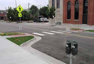 Detectable warning strips, a distinctive surface pattern of domes detectable by cane or underfoot, are now used to alert people with vision impairments of their approach to streets and