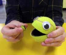 Feed the ball Get your child to hold marbles in one hand and the ball in the other hand. Encourage your child to manipulate marbles from palm of hand to finger tips.