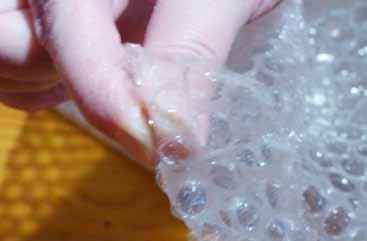 Popping bubble wrap Pop plastic bubbles using index finger and thumb.