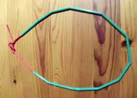 Using scissors to cut straws and make a necklace Encourage your child to hold the straw in one hand and the scissors in the other.