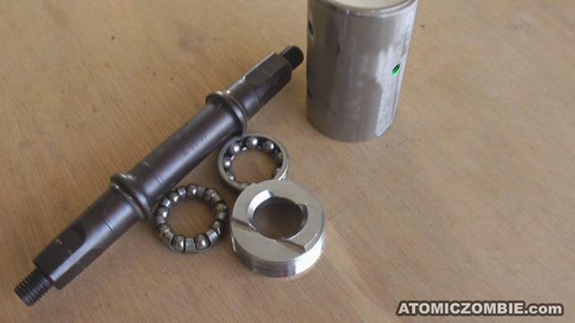 THE CRANK AXLE With the left side bearing cup removed, all of the parts can be removed