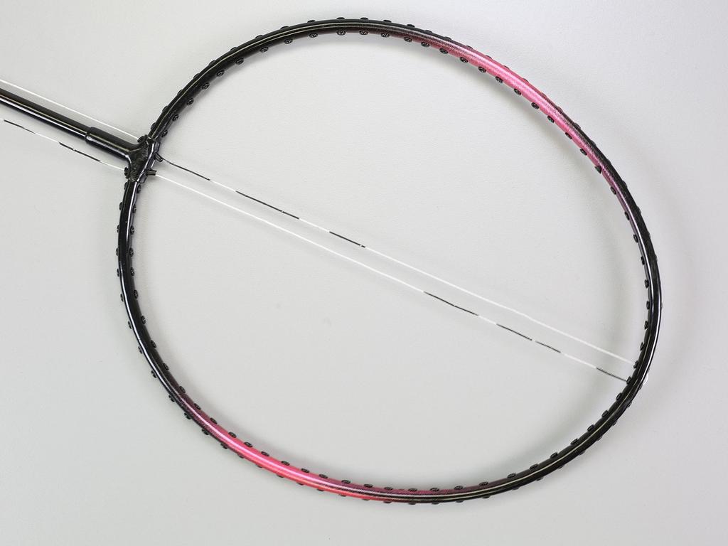 Step 1 Insert one end of the string through the hole at the bottom of the racquet closest to the shaft and drag it straight up to the corresponding hole at the top of the raquet.