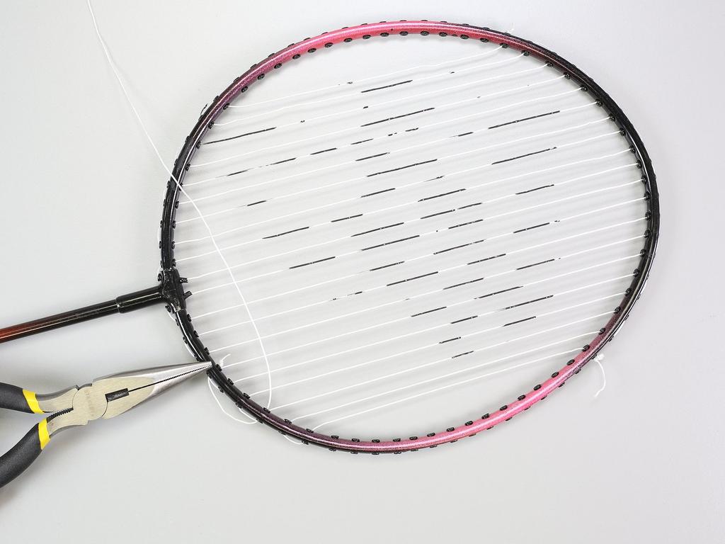 the racquet if you have trouble making a small, close knot with your fingers.