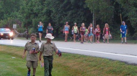 A large number of Brownies and a few Boy Scouts were handing out plastic