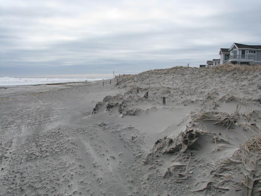 The beach is narrower and lower in elevation with the wet dry line at the seaward dune toe.