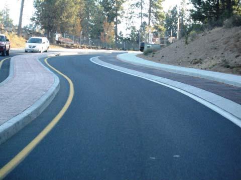 as a buffer between traffic for pedestrians Additional width improves sight distance along the inside of curves Lower traffic driveway crossings on east side of roadway Bicyclists and pedestrians in