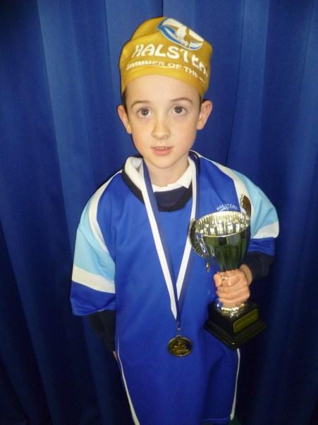 swimmer in his class, and he received the medals at a swimming