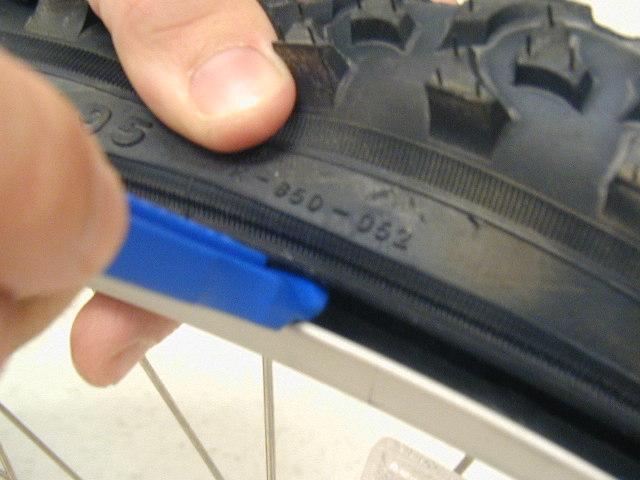 Flat Tire Using the flat end of the tire lever, separate the tire from the rim of the wheel moving the bead of the tire to the outside of the rim. It may be necessary to use 2 tire levers.