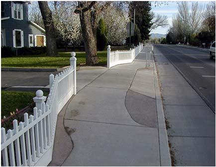 The sidewalk can wrap around the driveway ramp if needed to remain level, however this presents a challenge for those who have visual impairments. The photos below show example driveway designs.