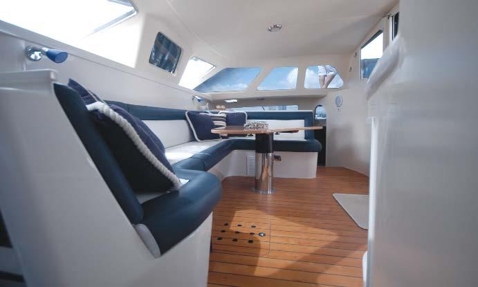 Out the back is a large entertainment area with a full-length lounge across the transom and another small dinette. It s shaded by the bridge deck hardtop and can be enclosed with canvas and clears.