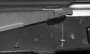 Next, rotate the bottom of the magazine rearward until the magazine release lever locks onto the rear locking surface of the magazine.