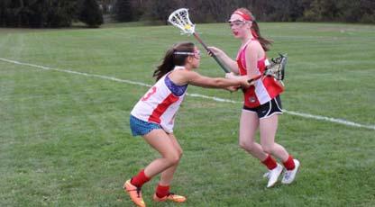 Defender drops head of stick to a horizontal position and