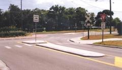 Mini-roundabouts may have splitter islands defined only by pavement markings.