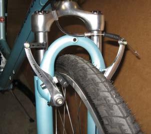 Spin so the brake cable does not wrap around the head tube. In proper position, the fork ends will face forward and brakes will be in front of the fork.