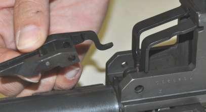 Test for correct assembly by pressing down on the front arms of the operating rod catch assembly (fig 45).