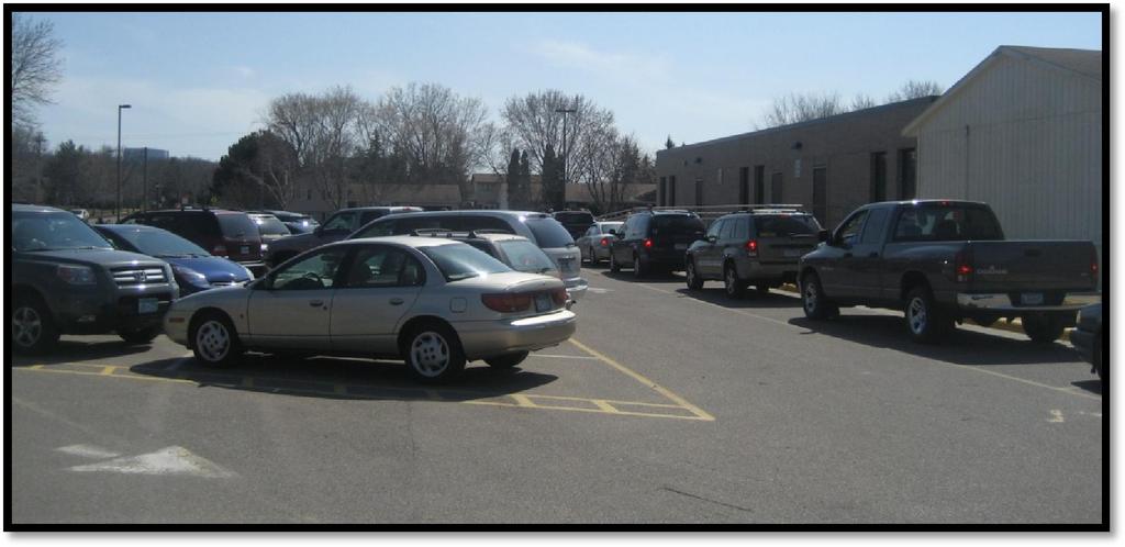 Queue of parent vehicles in the east parking lot prior to school dismissal.
