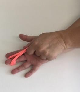 Grab the putty with the other hand then extend finger to a fully opened position with as much