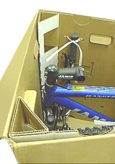 Choose the pair of holes in the fork mount which allow the head tube to be as close as possible to the front of the box without touching.