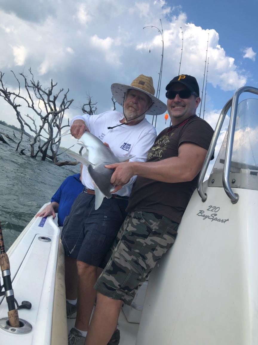 Captain Tommy Williams Inshore fish catching specialist of Miss Judy Charters is assisting Steve Duchi of Pittsburg, PA with his just caught bonnet