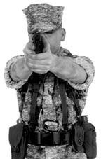Note: A left-handed Marine presses the slide release with his trigger finger. Figure 2-17. Present Pistol Back to Target.