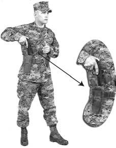 Ensure the muzzle is pointed in a safe direction. Establish a two-handed grip on the pistol by joining the left hand with the right hand in the front of the torso. See figure 4-5.