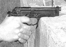 The pistol may be pushed up against the support so the V formed by the receiver and the front of the trigger guard rests firmly against the support. See figure 5-6.