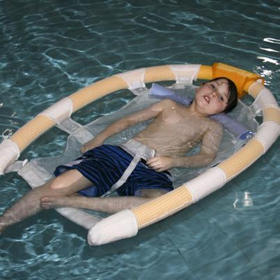 A specialist hydrotherapy swimming buoyancy aid such as this flotation sling should not be used without a full risk assessment and whilst it can be used to transfer an end user into and out of a pool
