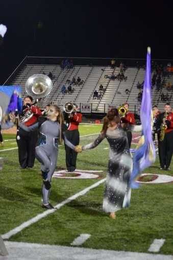Pictured here is the Alien, Katelyn McClure and Colorguard Member Ashton Gross grasping hands as a symbol of acceptance in the song Open Arms.