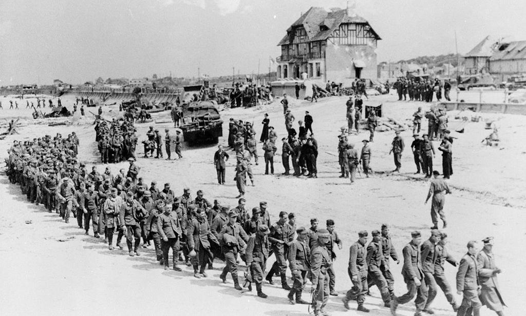June 6, 1944: German prisoners-of-war march along Juno Beach landing area