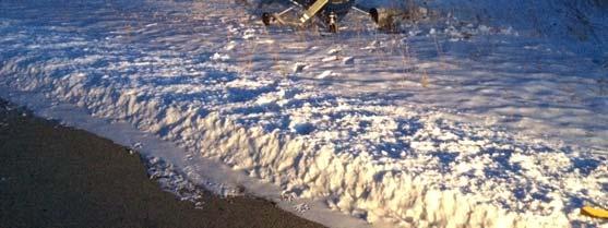 snow at the edge of the 2550x30 runway, and the aircraft departed the asphalt and rolled to a stop on snow covered turf.