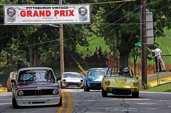 Rudi Glarner and his BMW 2002 lead the field down to the start.