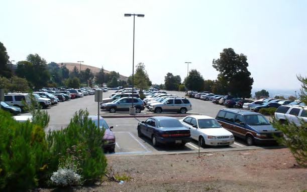 (upper) Parking Lot B, future student housing site. purposes, if current trends and policies continued, the University would need to supply parking at a rate of 0.
