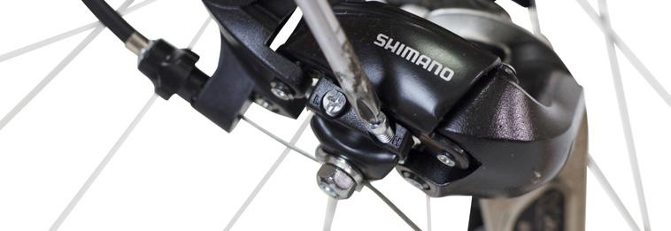 With a Phillips screwdriver, gradually turn the screw counterclockwise 1/4 turn at a time while rotating the pedal until the chain falls onto the smallest cog.