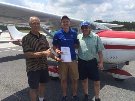 Left to right - FAA Examiner Bill Mercure, new private pilot Jack Emmons and his father Carlos
