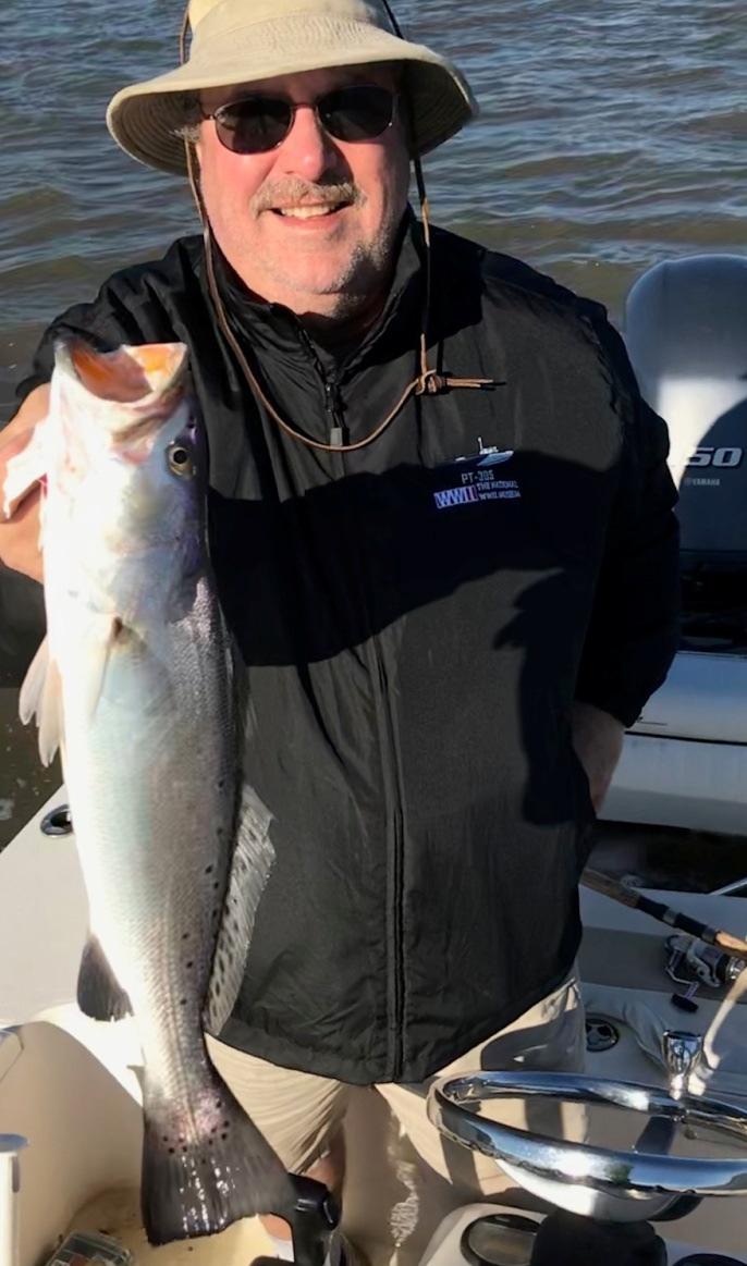 While inshore fishing with Captain Kevin Ross of Miss Judy Charters Jim Rapkin Grayson Georgia is holding up a nice spotted sea trout!
