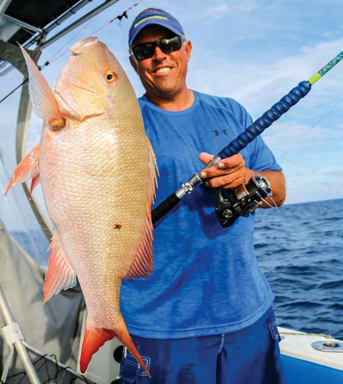 Capt. Ryan holds a fine mutton snapper caught while yellow- tailing a common occurrence when fishing near the reef in the Keys. time, the fish get lethargic.