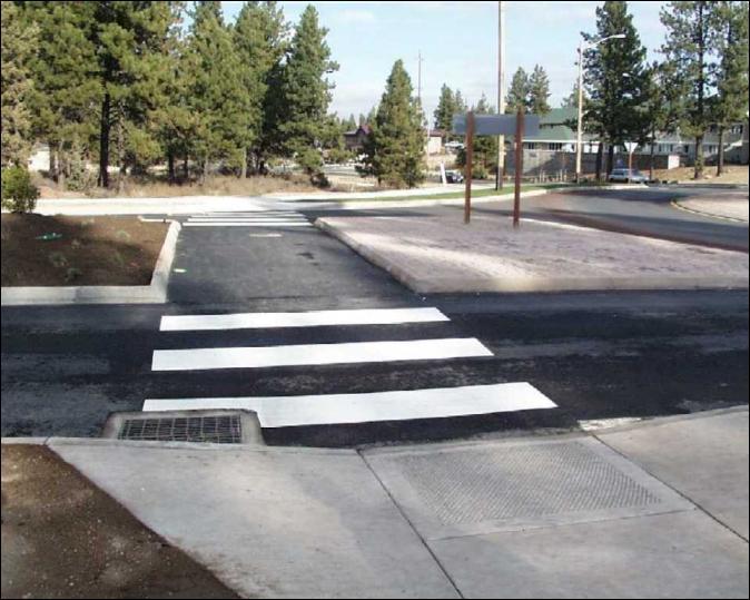 crossing. Curvilinear pedestrian crossings should also be avoided. Curb ramps should be centered on the pedestrian crossing. Avoid placing drainage structures in the crossing area.