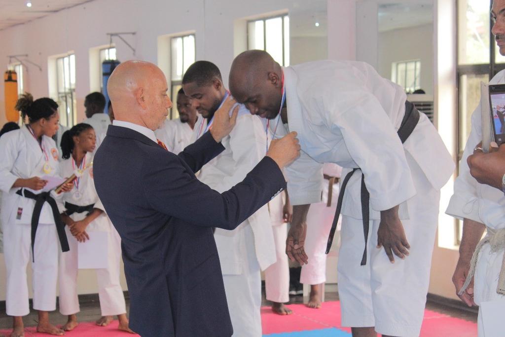 On the left: Bamgboye Sensei presenting the Male Category Winner Sensei Ibrahim with his gold medal after a tight finish that saw his sublime transitions in his Gojushiho performance triumph over