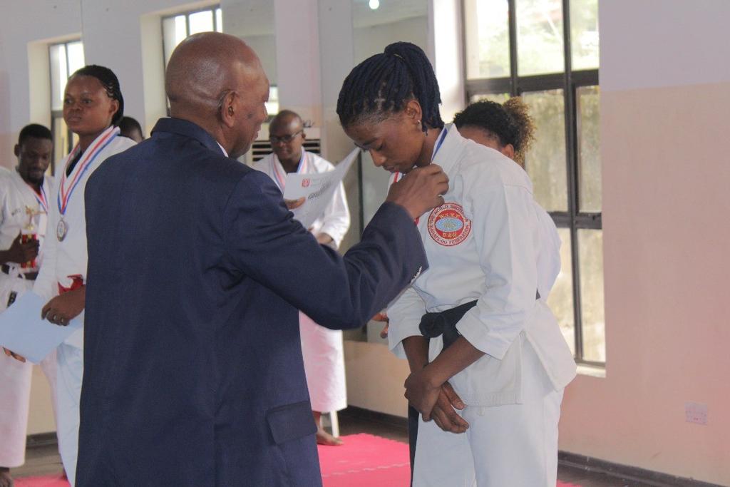 Below: Mezie-Okoye Sensei as he decorates the female category silver medal with her. She put up a spirited display but fell short to Gold medallist Ujunwa Nwankwo.
