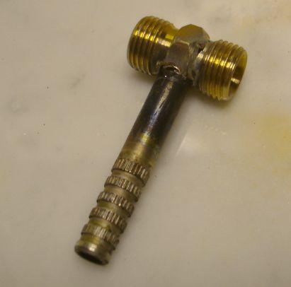I used a drill press with a 1/4" bit to drill part way into the center of the brass union.