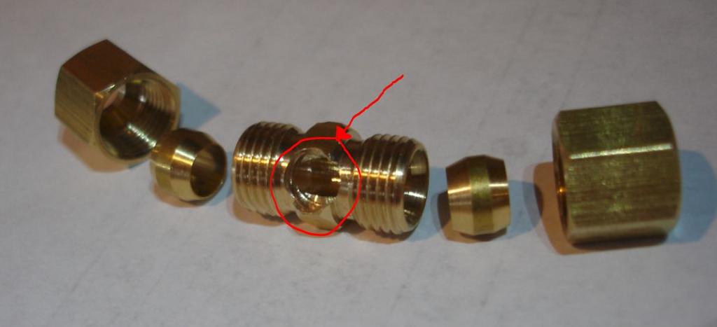 I removed some of the tapered end of the 1/4" metal supply pipe using a bastard file until it fit nicely into the hole that was drilled in the brass union.