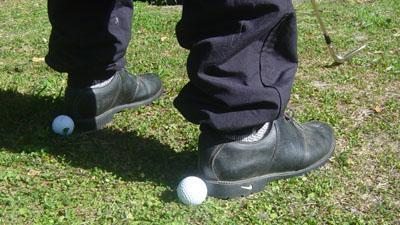A simple way of checking your feet alignment is to place balls behind your feet after you've setup.then simply move away and check to see where your feet are lined up to.