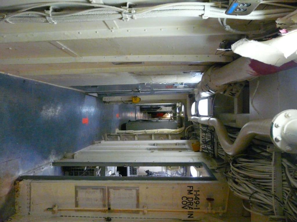 Main Ship Passageway Aft This was taken from the MT 52 Carrier Room looking forward. As you can see the tile are coming off the deck and will need to be replace with a terrazzo type deck.