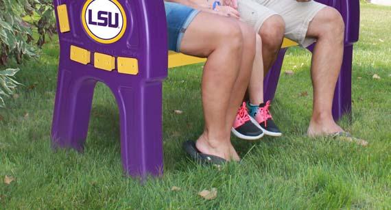 the bench can hold up to 600 pounds. The purple sides of the bench each feature the LSU logo prominently displayed.